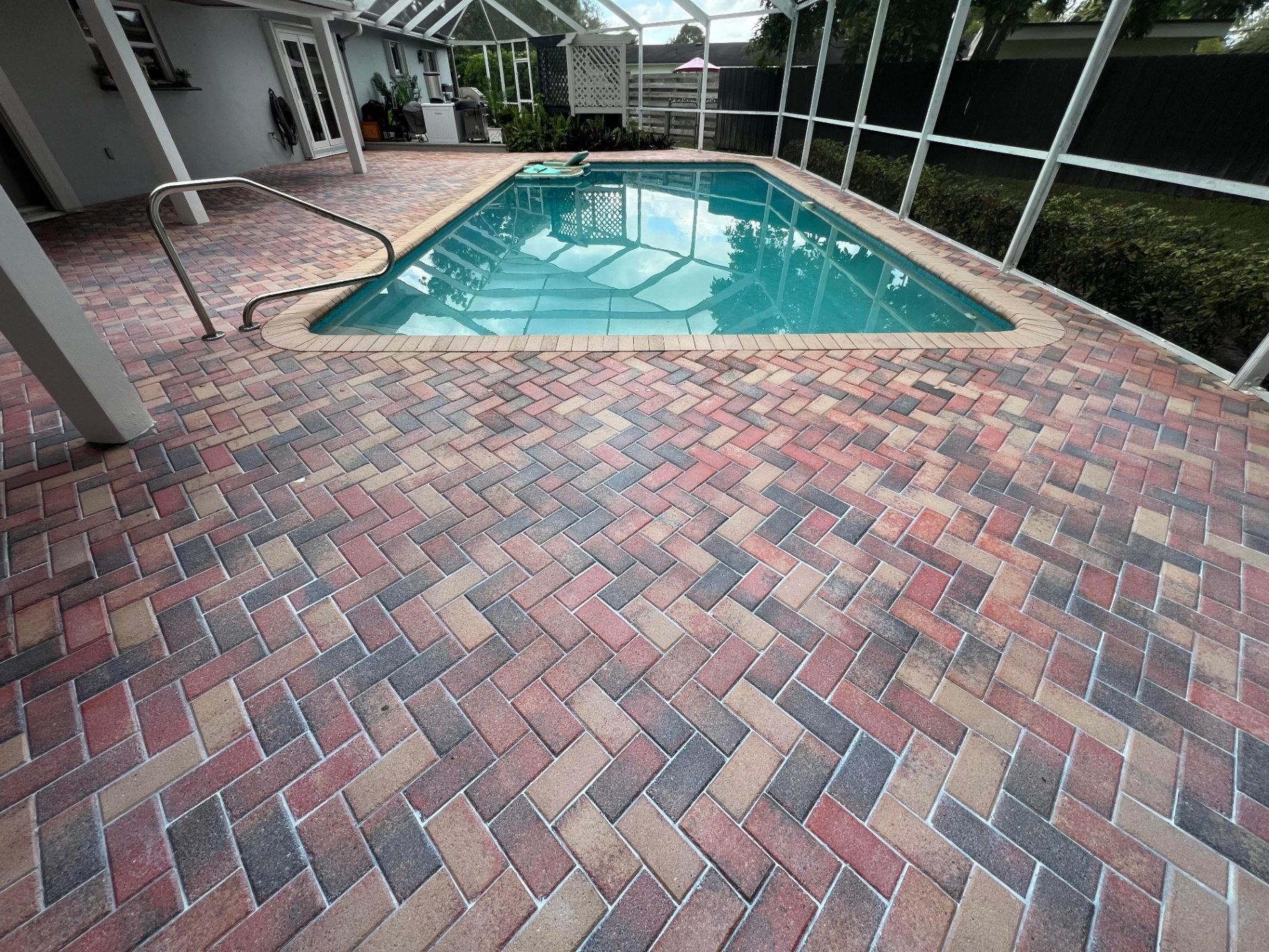 Sealed travertine and paver pool deck