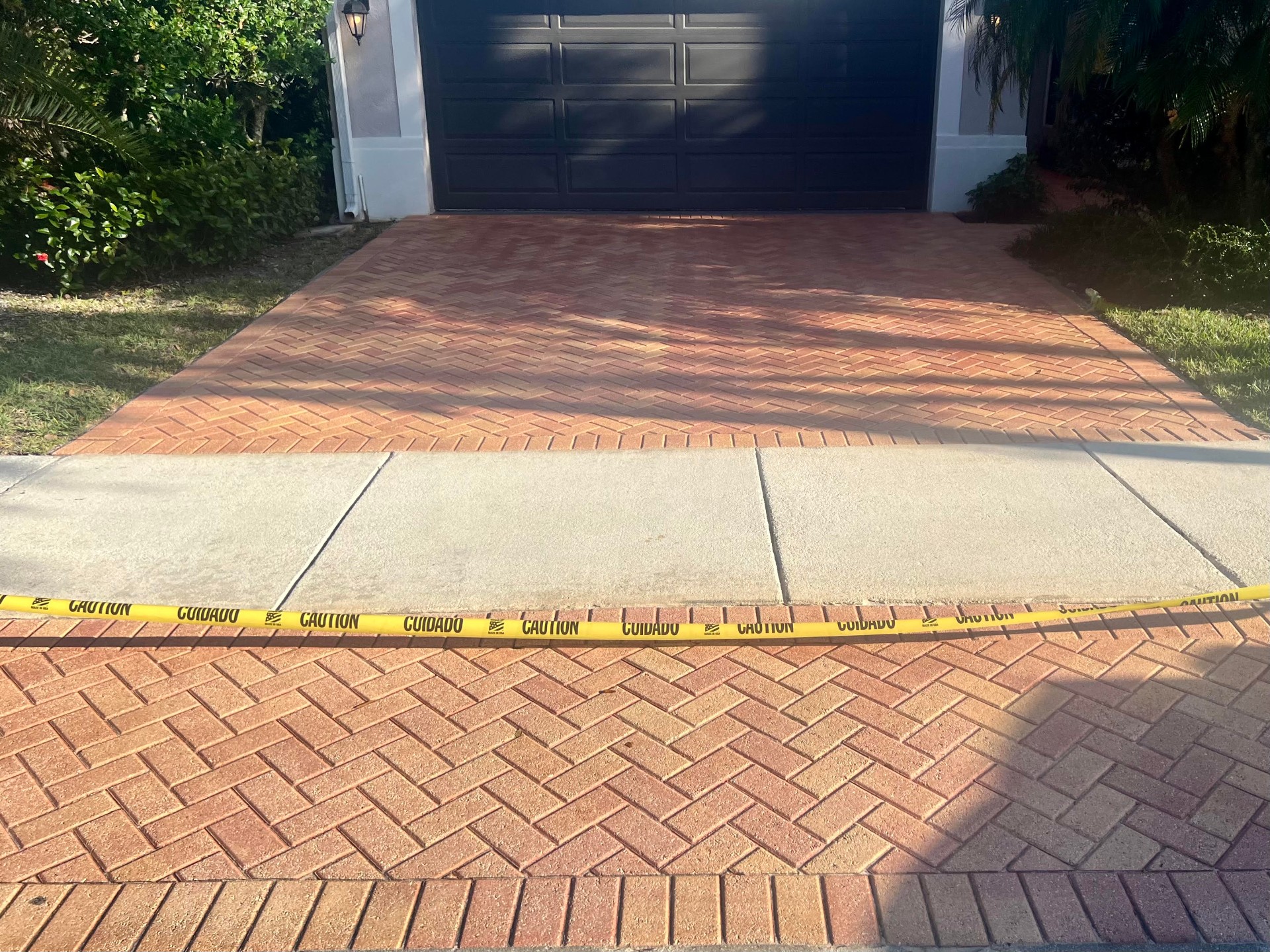 Same brick paver driveway after cleaning, sanding, and sealing by Patty's Sealing