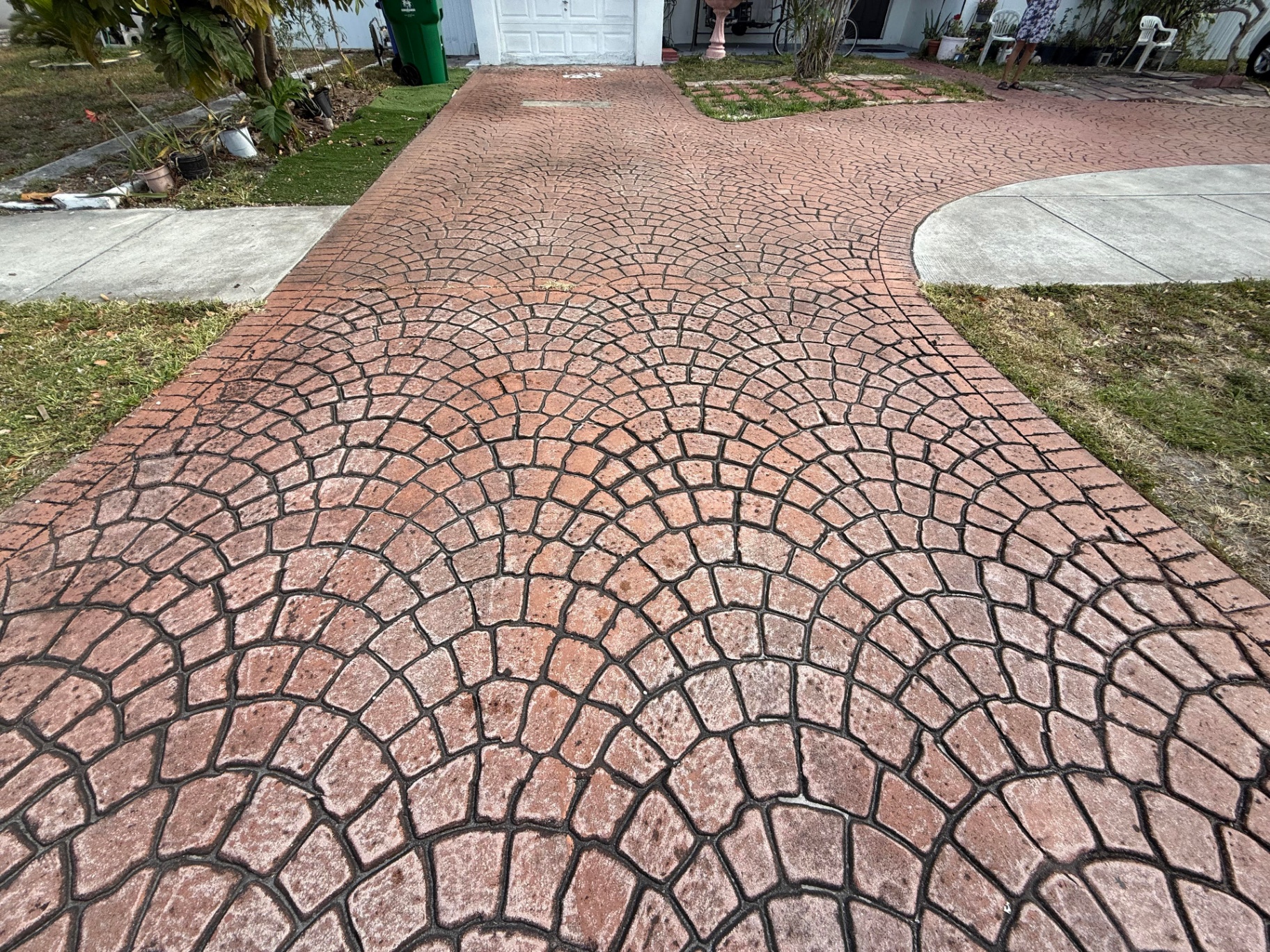 Faded stamped concrete driveway before sealing